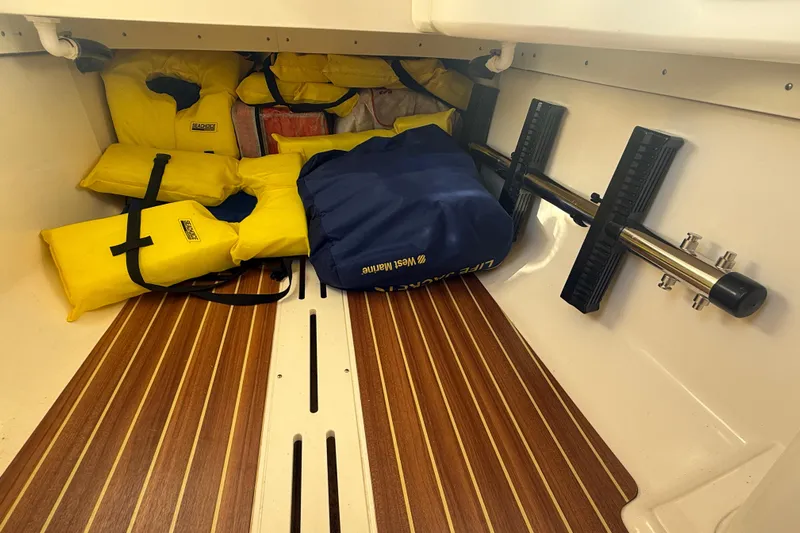 T/t B Happy Yacht Photos Pics Storage area of 2019 Scout 320 LXF with life jackets and equipment.