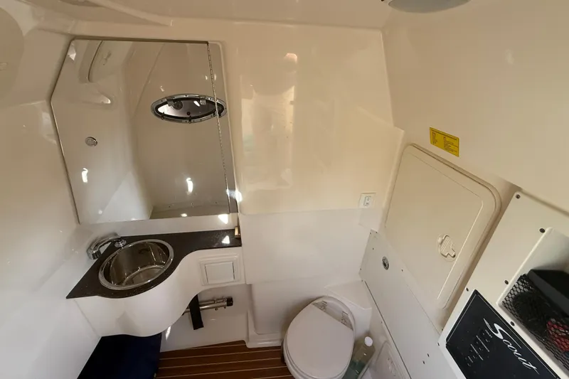 T/t B Happy Yacht Photos Pics 2019 Scout 320 LXF boat interior with sink, toilet, and mirror.