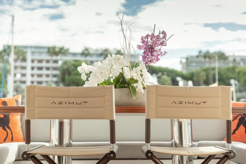 Solstice Yacht Photos Pics Azimut 72 Flybridge 2020 yacht chairs with floral arrangement, outdoor luxury setting.