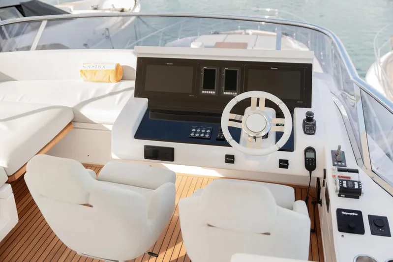 Solstice Yacht Photos Pics Flybridge helm of 2020 Azimut 72, featuring dual seats and modern navigation controls.