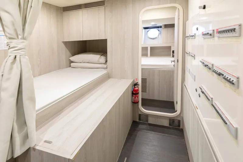Solstice Yacht Photos Pics 2020 Azimut 72 Flybridge cabin interior with bed, storage, and porthole window.