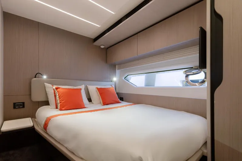 Solstice Yacht Photos Pics Luxurious bedroom interior of 2020 Azimut 72 Flybridge yacht with modern design and orange accents.