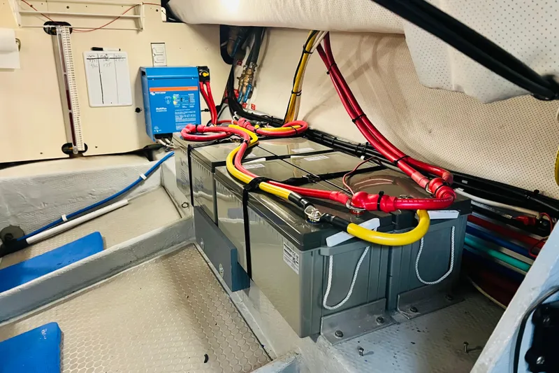 Tranquil Tides Yacht Photos Pics Engine room of 2006 Mainship 34 Trawler with batteries and wiring.