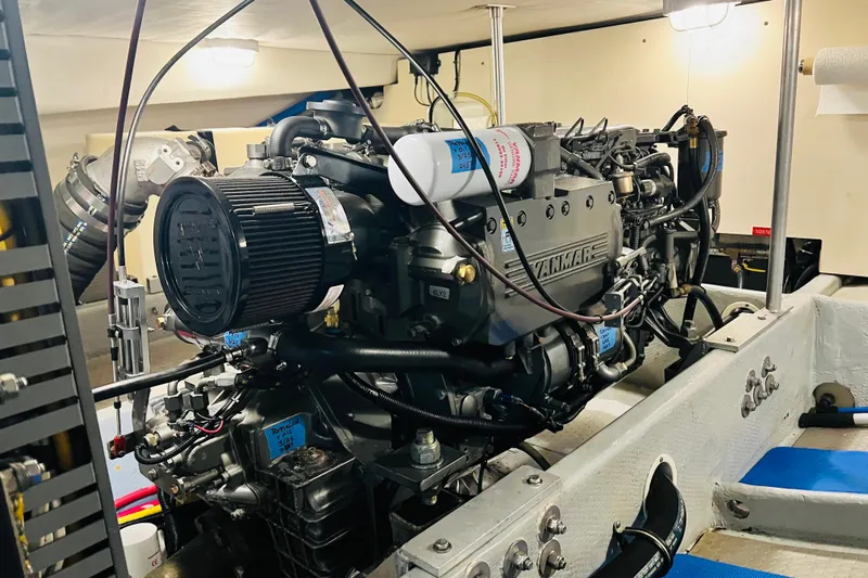 Tranquil Tides Yacht Photos Pics Engine room of 2006 Mainship 34 Trawler showcasing Yanmar engine components.