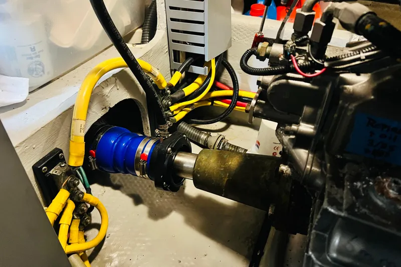 Tranquil Tides Yacht Photos Pics Engine room of 2006 Mainship 34 Trawler with visible wiring and components.