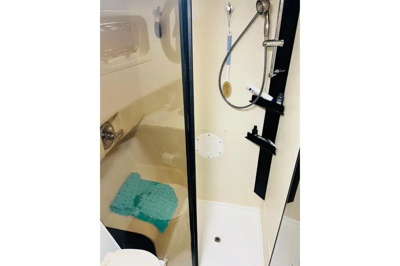Tranquil Tides Yacht Photos Pics Bathroom shower area in 2006 Mainship 34 Trawler with modern fixtures and accessories.