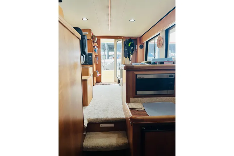 Tranquil Tides Yacht Photos Pics Interior of 2006 Mainship 34 Trawler with modern kitchen and cozy living space.