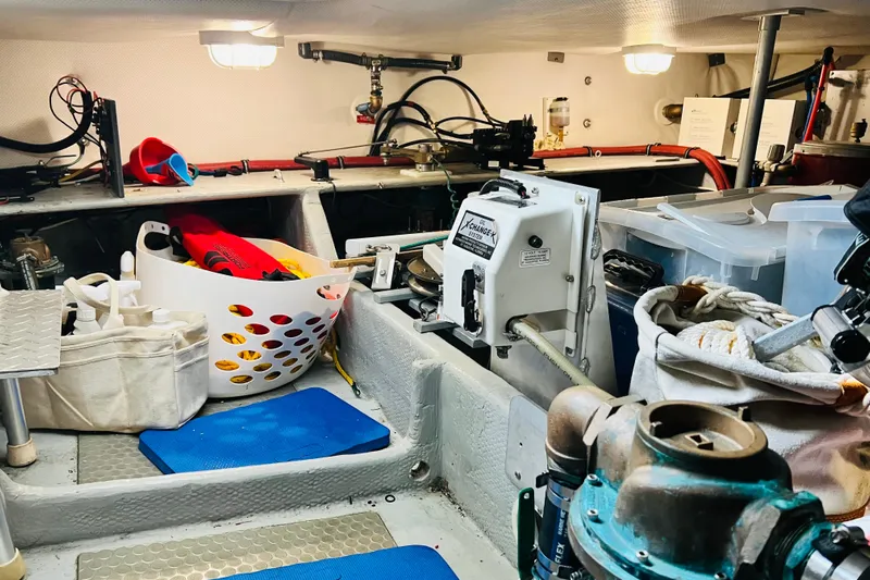 Tranquil Tides Yacht Photos Pics Engine room of 2006 Mainship 34 Trawler with organized storage and equipment.