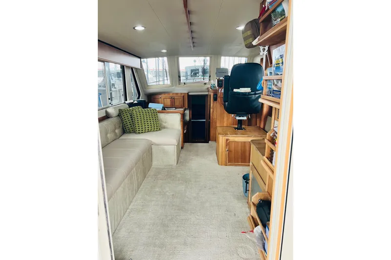 Tranquil Tides Yacht Photos Pics Interior of 2006 Mainship 34 Trawler with seating, helm, and storage shelves.