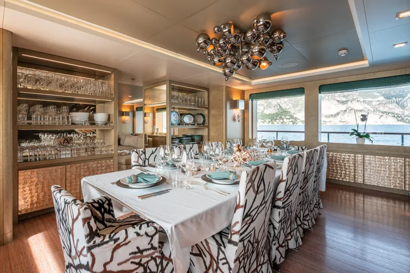 Liberty Yacht Photos Pics Luxurious dining area on 2011 ISA 50M yacht with elegant table setting and scenic ocean view.