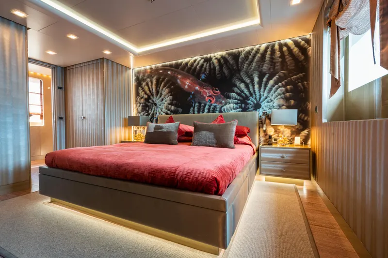 Liberty Yacht Photos Pics Luxurious bedroom on 2011 ISA 50M yacht with modern decor and underwater-themed wall art.