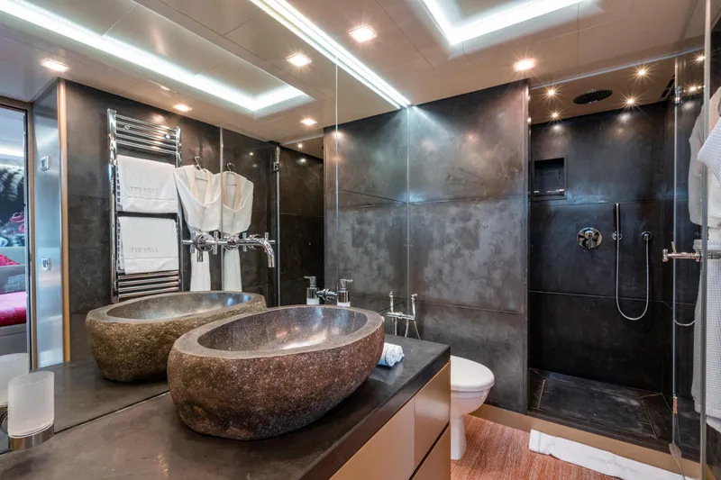 Liberty Yacht Photos Pics Modern yacht bathroom with stone sinks, glass shower, and sleek lighting, ISA 50M 2011 model.