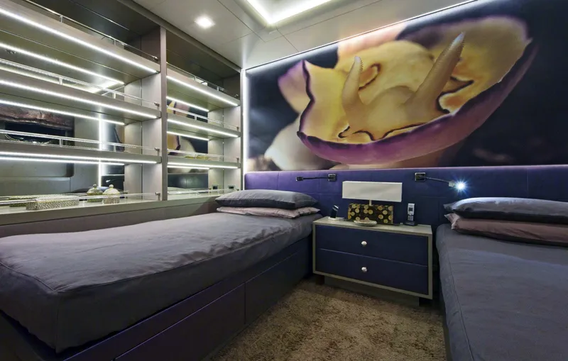 Liberty Yacht Photos Pics Modern yacht bedroom with twin beds, mirrored wall, and large floral artwork. ISA 50M, 2011 model.