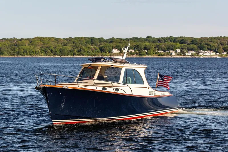 Brendan Yacht Photos Pics 2018 Hinckley Picnic Boat 37 MKIII cruising on open water with American flag.