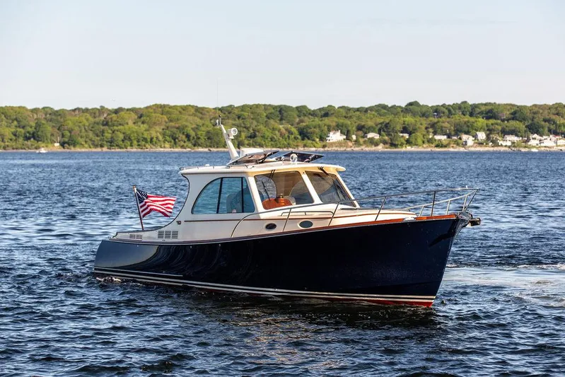 Brendan Yacht Photos Pics 2018 Hinckley Picnic Boat 37 MKIII cruising on a scenic lake with lush green shoreline.
