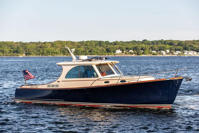 Brendan Yacht Photos Pics 2018 Hinckley Picnic Boat 37 MKIII cruising on a calm lake with scenic shoreline.
