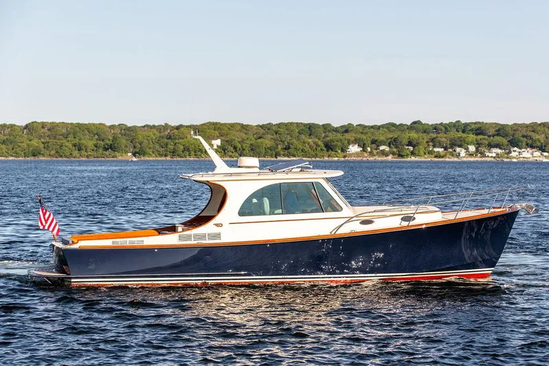 Brendan Yacht Photos Pics 2018 Hinckley Picnic Boat 37 MKIII cruising on a calm lake with scenic shoreline.