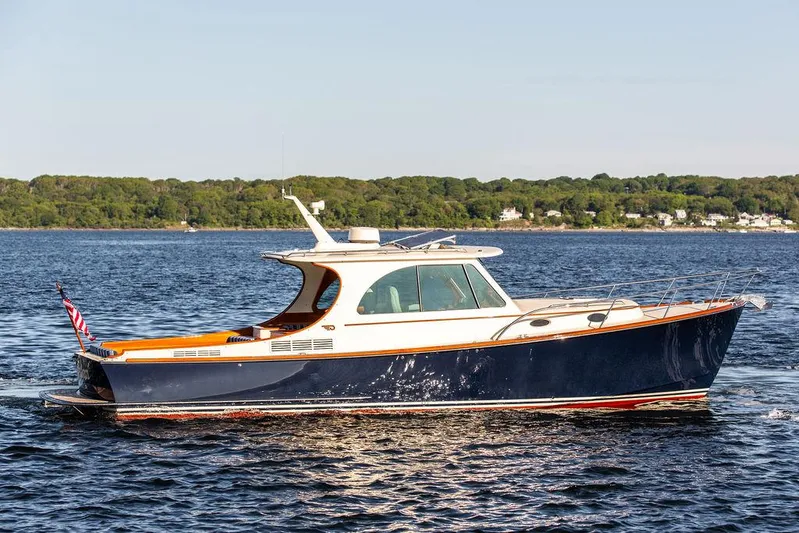 Brendan Yacht Photos Pics 2018 Hinckley Picnic Boat 37 MKIII cruising on a calm lake with scenic shoreline.