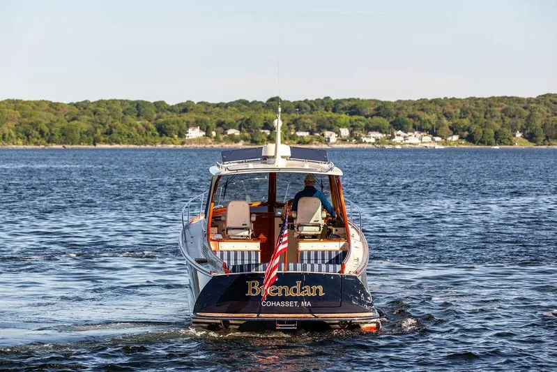 Brendan Yacht Photos Pics 2018 Hinckley Picnic Boat 37 MKIII cruising on a scenic lake with lush green shoreline.