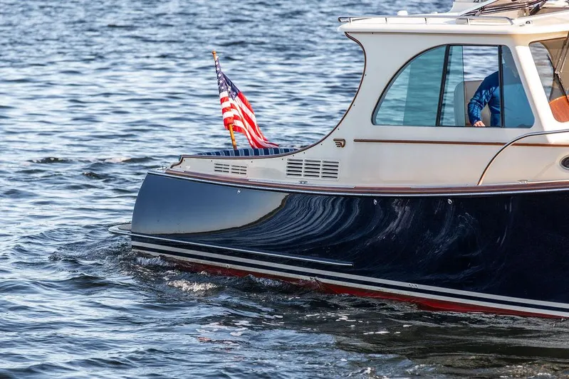 Brendan Yacht Photos Pics 2018 Hinckley Picnic Boat 37 MKIII cruising on water with American flag.