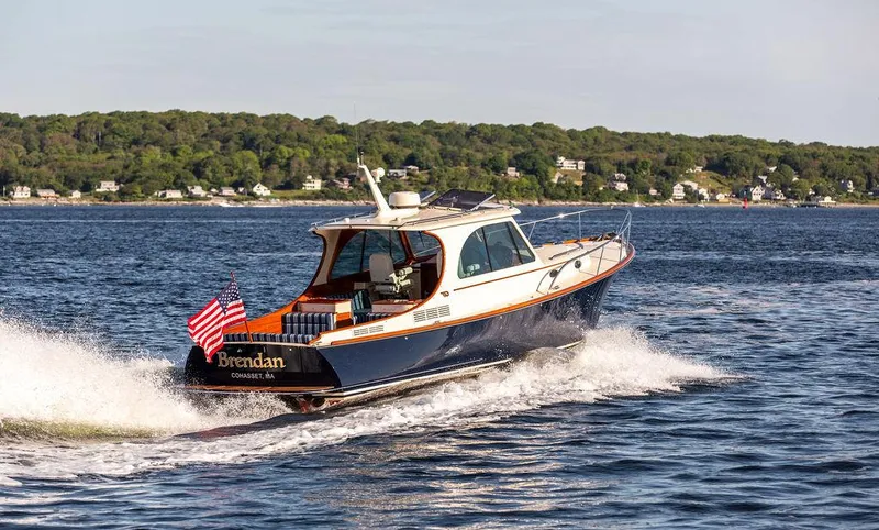 Brendan Yacht Photos Pics 2018 Hinckley Picnic Boat 37 MKIII cruising on open water, American flag displayed.