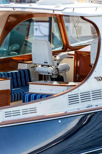 Brendan Yacht Photos Pics 2018 Hinckley Picnic Boat 37 MKIII interior with striped seating and helm chair.