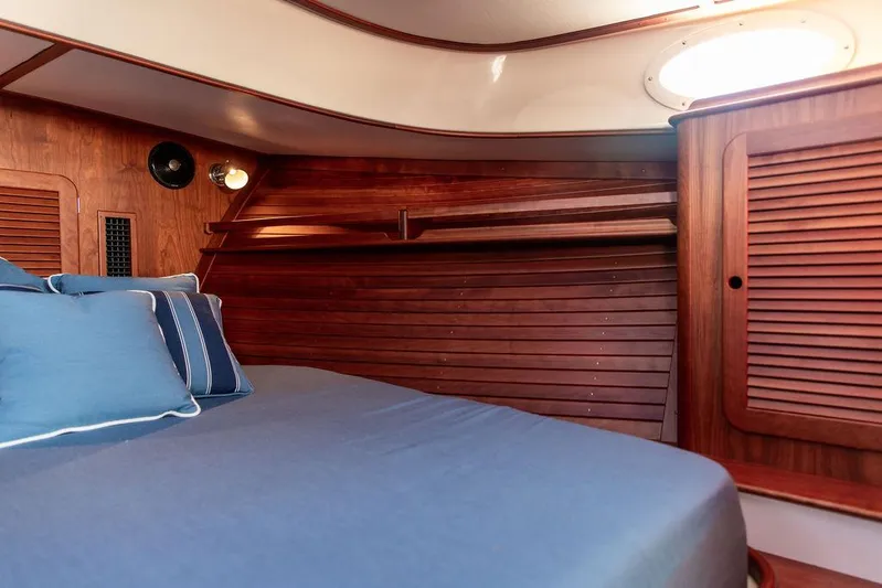 Brendan Yacht Photos Pics 2018 Hinckley Picnic Boat 37 MKIII cabin with wooden interior and blue bedding.