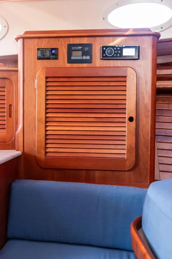 Brendan Yacht Photos Pics 2018 Hinckley Picnic Boat 37 MKIII interior with wooden paneling and blue seating.