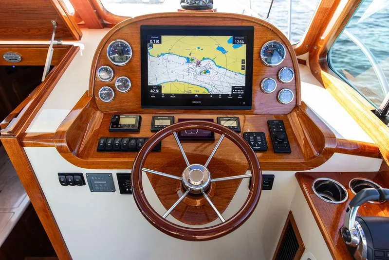 Brendan Yacht Photos Pics Helm of 2018 Hinckley Picnic Boat 37 MKIII with navigation display and wooden steering wheel.