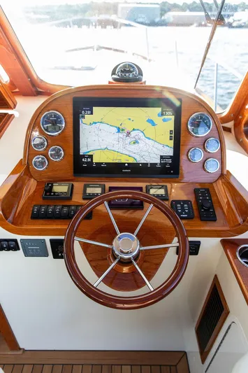 Brendan Yacht Photos Pics Helm of 2018 Hinckley Picnic Boat 37 MKIII with navigation display and wooden steering wheel.