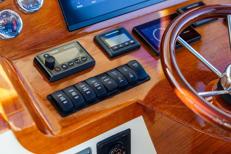 Brendan Yacht Photos Pics Helm controls of 2018 Hinckley Picnic Boat 37 MKIII with wooden finish and modern instruments.