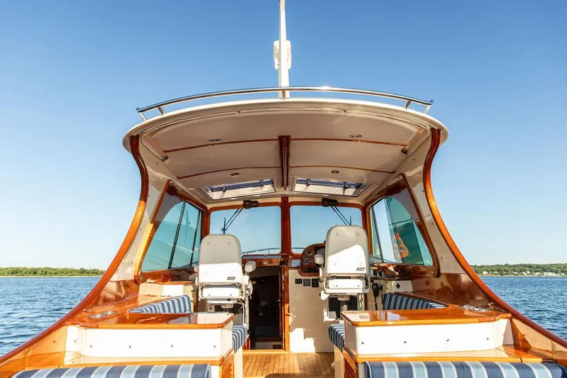 Brendan Yacht Photos Pics 2018 Hinckley Picnic Boat 37 MKIII interior with elegant seating and helm, on calm water.