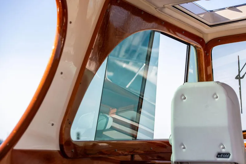 Brendan Yacht Photos Pics Interior view of 2018 Hinckley Picnic Boat 37 MKIII, showcasing window and seating.