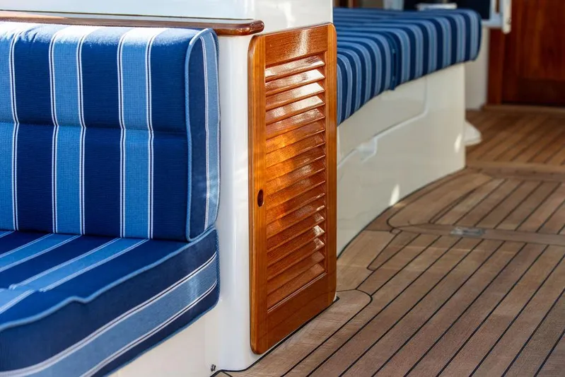 Brendan Yacht Photos Pics Hinckley Picnic Boat 37 MKIII 2018 interior with blue striped seating and wooden accents.