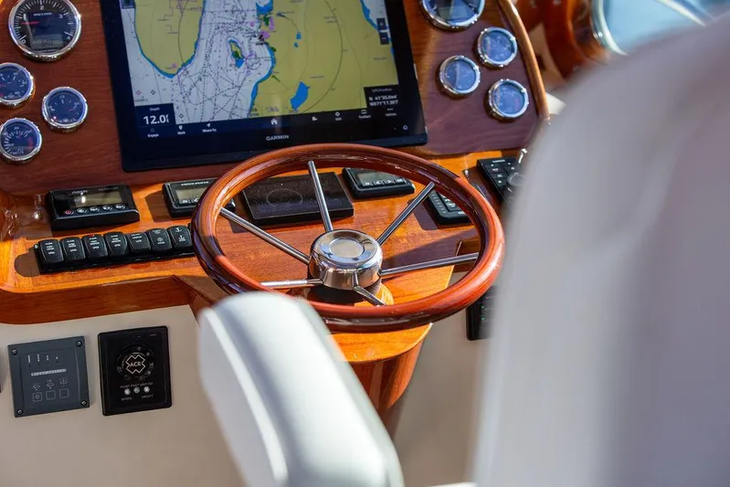 Brendan Yacht Photos Pics Helm of 2018 Hinckley Picnic Boat 37 MKIII with navigation display and wooden steering wheel.