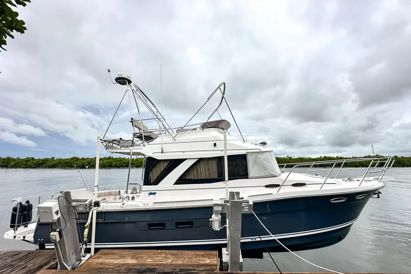  Yacht Photos Pics 2022 Cutwater 30 Command Bridge boat docked on a cloudy day.