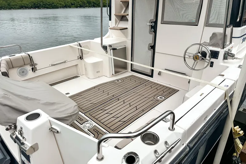  Yacht Photos Pics 2022 Cutwater 30 Command Bridge boat interior with teak flooring and steering wheel.
