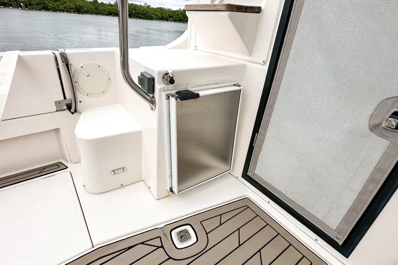  Yacht Photos Pics 2022 Cutwater 30 Command Bridge boat interior with stainless steel door and seating area.