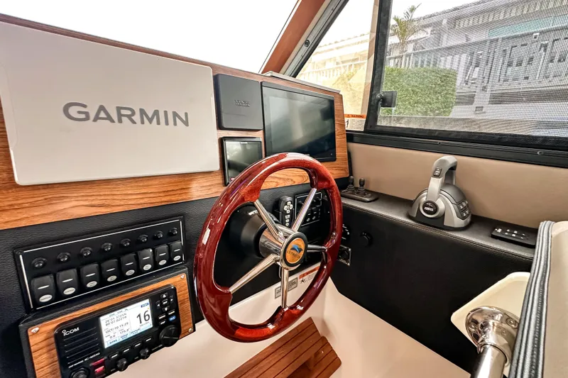  Yacht Photos Pics 2022 Cutwater 30 Command Bridge helm with Garmin navigation and wood accents.