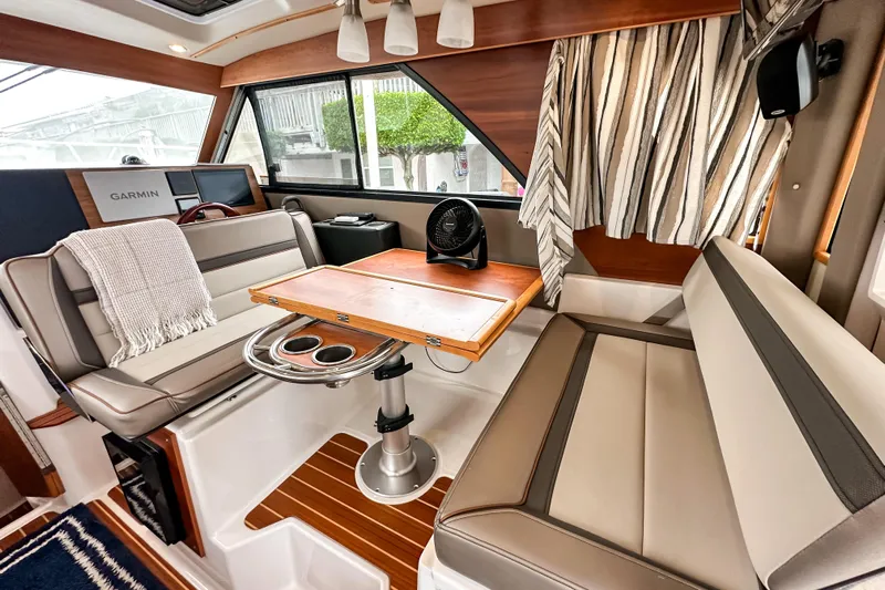  Yacht Photos Pics Interior of 2022 Cutwater 30 Command Bridge with seating, table, and Garmin navigation system.