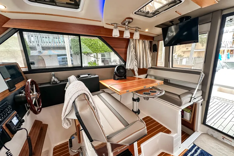  Yacht Photos Pics 2022 Cutwater 30 Command Bridge interior with seating, table, and modern amenities.
