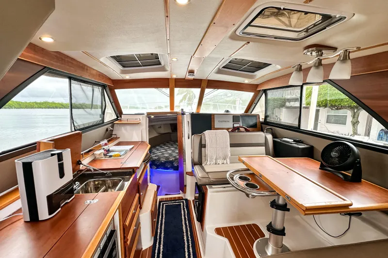  Yacht Photos Pics Interior of 2022 Cutwater 30 Command Bridge, featuring modern amenities and elegant wood finishes.