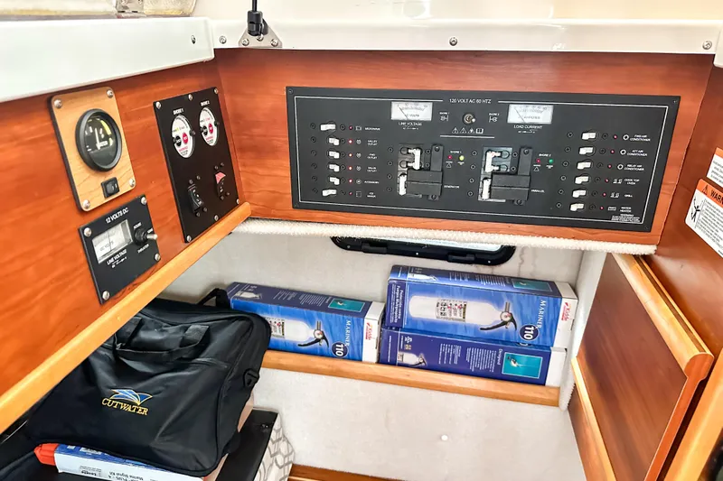  Yacht Photos Pics Electrical panel and storage area inside a 2022 Cutwater 30 Command Bridge boat.