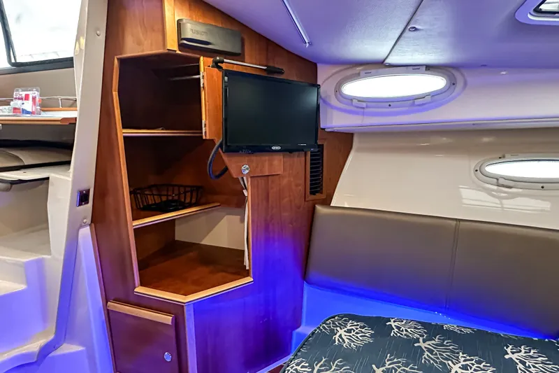  Yacht Photos Pics Interior of 2022 Cutwater 30 Command Bridge with TV and shelving.