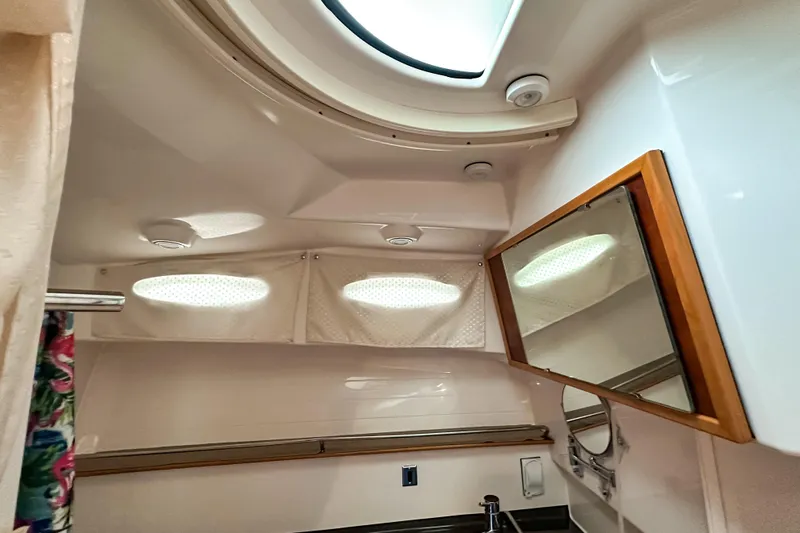  Yacht Photos Pics Interior of 2022 Cutwater 30 Command Bridge bathroom with skylight and mirror.