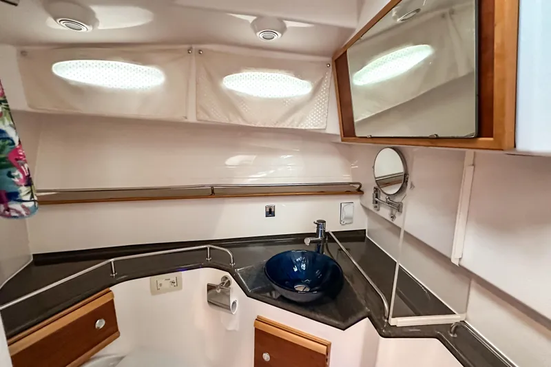  Yacht Photos Pics 2022 Cutwater 30 Command Bridge bathroom with modern sink and mirror.