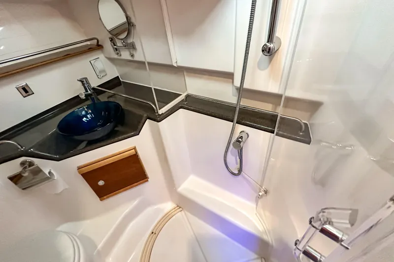  Yacht Photos Pics 2022 Cutwater 30 Command Bridge bathroom with modern sink and shower.