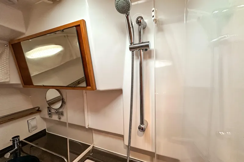  Yacht Photos Pics Bathroom interior of 2022 Cutwater 30 Command Bridge with shower and mirrors.