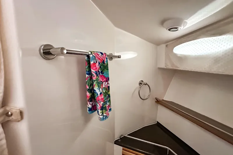  Yacht Photos Pics 2022 Cutwater 30 Command Bridge bathroom with towel rack and colorful towel.