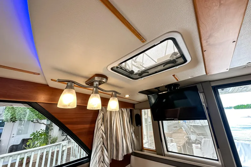  Yacht Photos Pics Interior of 2022 Cutwater 30 Command Bridge with modern lighting and ceiling hatch.